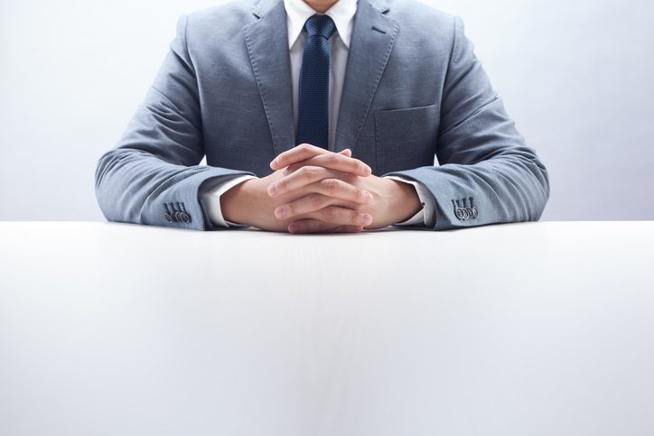 Stephen C. Carter, PC Attorney at Law | Hartwell, GA | businessman sitting at desk with hands folded